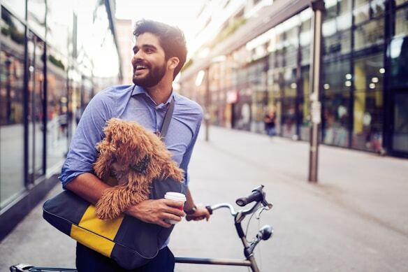 Man holding dog and bicycle